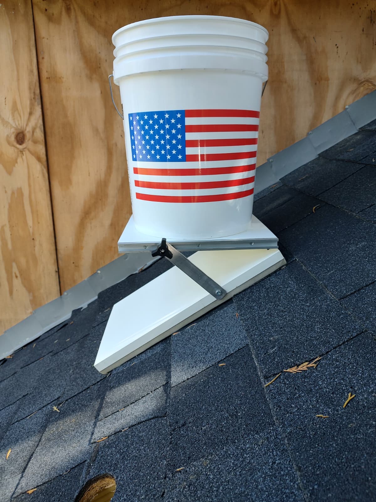 Roofer using the Roof Stable Table on a steep asphalt-shingle roof